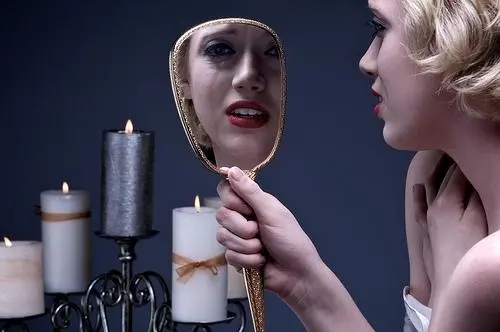 crying-woman-looking-mirror